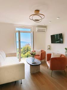 リエカにあるLuxury Apartment AMÉS Rijekaのソファと椅子とテーブルのあるリビングルーム