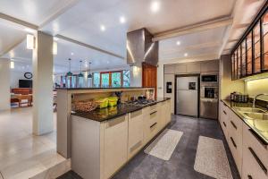 a large kitchen with a sink and a counter at Da Vinci The Villa by Nagisa Bali in Tumbak Bayuh