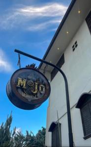 a sign hanging from the side of a building at Mojo Hostel in Puerto Princesa City