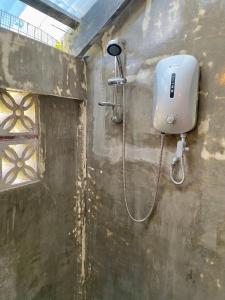 a shower in a wall with a shower head at Mojo Hostel in Puerto Princesa City