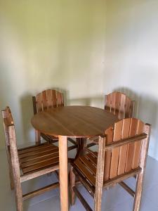 a wooden table with two chairs and a wooden table and chairsktop at Raja Ampat Family Guest House in Saonek +19 photos
