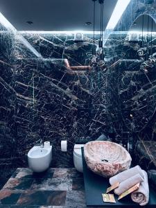 a marble bathroom with a sink and a toilet at La casa di SELLY 3 - A 10 Metrì Dal Mare- in Bergeggi