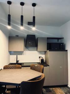 a dining room with a table and chairs and lights at La casa di SELLY 3 - A 10 Metrì Dal Mare- in Bergeggi