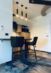 a dining room with a table and two chairs at La casa di SELLY 3 - A 10 Metrì Dal Mare- in Bergeggi