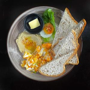 a plate of breakfast food with eggs and toast at Mojo Hostel in Puerto Princesa City