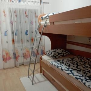 a bedroom with a bunk bed and a ladder at Petra in Livno +4 photos