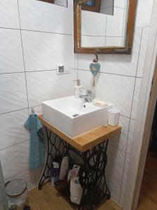 a bathroom with a white sink and a mirror at Domek z kominkiem, Ukta 63, Mazury, in Ruciane-Nida +16 photos