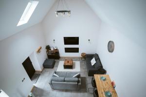 an overhead view of a living room with a couch and a table at The Byre at Conker Tree Cottages in Saintfield