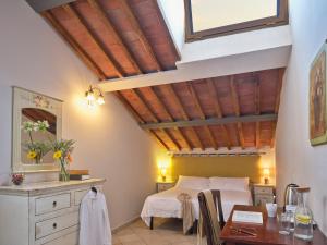 a bedroom with a bed and a desk and a table at I Terzi Di Siena - Rooms Only in Siena