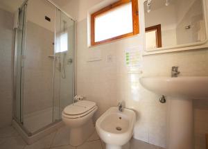 a bathroom with a toilet and a sink and a shower at Hotel Danila in Portoferraio