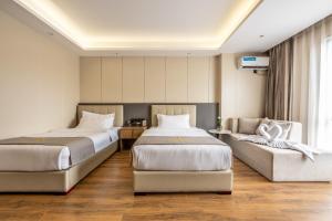 Postel nebo postele na pokoji v ubytování Bole Jing Pin Hotel
