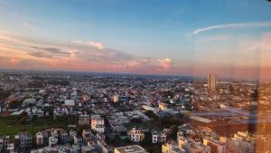 a view of a city with a rainbow in the sky at Bcons Garden Luxury Aparment in Dĩ An
