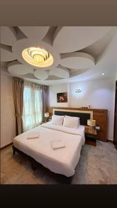 Postel nebo postele na pokoji v ubytování ريلاكس إن للشقق الفندقية Relax Inn Hotel Appartment