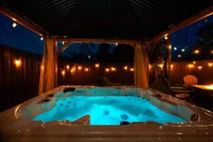 a hot tub in a gazebo at night at Brick Enclave with Mini Golf & SPA, 5mins to beach in Naples