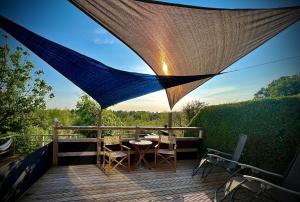 a patio with a table and chairs on a deck at Countryside in the Town. in Harlescott +5 photos