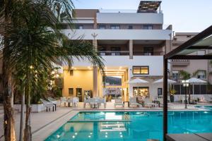 a swimming pool in front of a building at Sapphire Blue Suites in Kissamos +66 photos