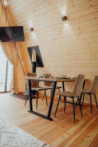 a dining room with a table and chairs at Memories Carpaty in Mizhhirʼʼya +81 photos