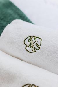 a close up of a white towel with a logo at Villa Monster in Mrągowo