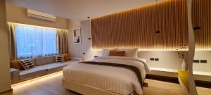 a bedroom with a bed and a large window at Cocohut Beach Resort Koh Phangan in Haad Rin