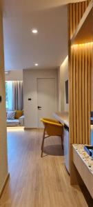 a living room with a table and a yellow chair at Cocohut Beach Resort Koh Phangan in Haad Rin