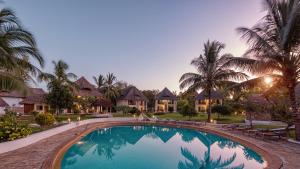 a swimming pool in front of a villa at Filao Beach by Sansi in Uroa