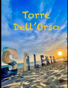 a sign on the beach with the words future del once at LE DUNE Casa vacanze Salento Puglia in Torre dell'Orso