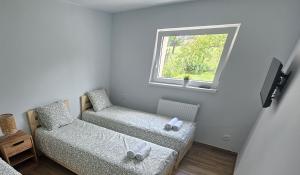 a small room with two chairs and a window at Apartament Wojska Polskiego 45 in Wadowice
