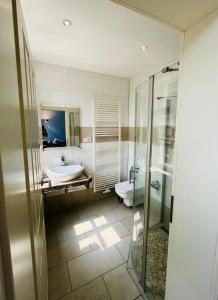 a bathroom with two sinks and a toilet and a shower at Lateinschule in Tecklenburg +92 photos
