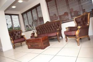 a living room with two chairs and a couch at Grosvenor Hotel Rugby in Rugby