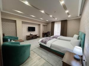a hotel room with a bed and a tv at Ахсикент отель in Namangan