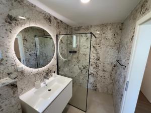a bathroom with a sink and a mirror at Villa Jolanda Beachside Residence in Orebić +11 photos