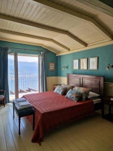 a bedroom with a large bed with a large window at Villa on Luštica peninsula with fantastic sea view in Mitrovići +50 photos