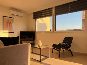 a living room with a couch and a chair and a table at M P A Luxury Apartment Α2 in Agios Nikolaos
