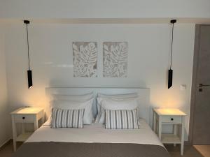 a bedroom with a white bed with two night stands at M P A Luxury Apartment Α2 in Agios Nikolaos