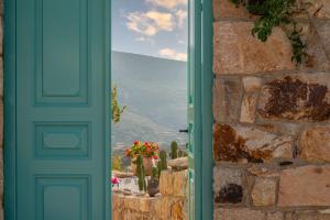a door with a view of a mountain through a window at Demati house in Patmos