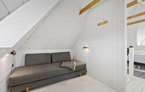 a couch sitting in the corner of a room at Two-Bedroom Holiday Home In Ringkobing in Ringkøbing +16 photos