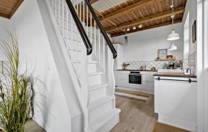 a kitchen with white walls and wooden ceilings at Two-Bedroom Holiday Home In Ringkobing in Ringkøbing