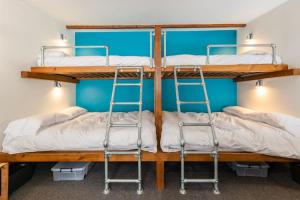 two bunk beds in a room with blue walls at Cosy Glamping In the Eskdale Valley - Studio Lodges and Mega Pods in Eskdale +108 photos