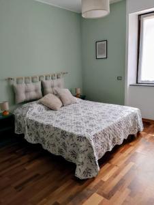 a bedroom with a bed with a comforter on it at Appartamento Casa Libe in Ornavasso