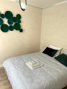 a bedroom with a bed with a towel on it at Charmant appartement Grand Stade in Villeneuve d'Ascq +1 photo