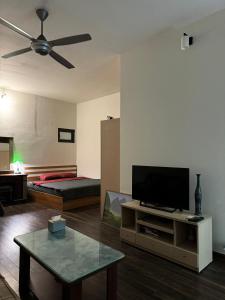 a living room with a flat screen tv and a bed at Fam Friendly-Center Old Quater-Super Location in Hanoi +7 photos