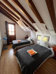 a bedroom with two beds in a attic at Kite House Tarifa in Tarifa