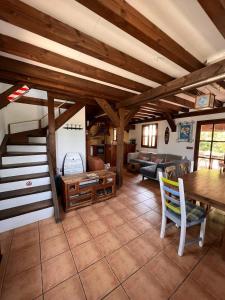 a living room with wooden ceilings and a table and chairs at Kite House Tarifa in Tarifa +20 photos