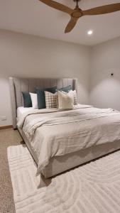 a bedroom with a large bed with blue and white pillows at The Stables Nug Nug Ranch in Buffalo River