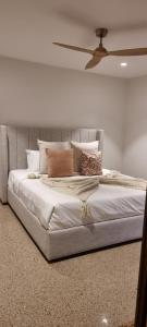 a bedroom with a large bed with pillows on it at The Stables Nug Nug Ranch in Buffalo River