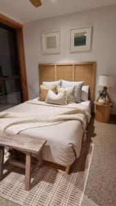 a bedroom with a large bed with a wooden headboard at The Stables Nug Nug Ranch in Buffalo River