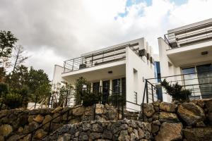 a white house with a stone wall at The Stay Christmas in Jeju