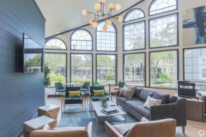 a living room with a couch and chairs and windows at Wyndham 915 1br Gem Perfect For Couple in Hampton