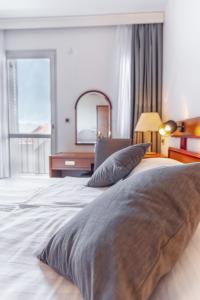Posteľ alebo postele v izbe v ubytovaní Hotel Horizont