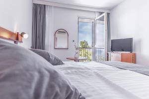 Posteľ alebo postele v izbe v ubytovaní Hotel Horizont